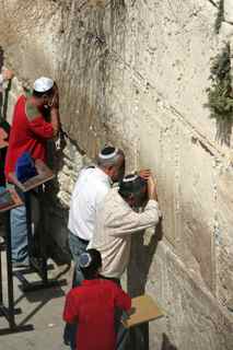 Jewish Men Pray at the Western Wall, Watched by a Young Boy