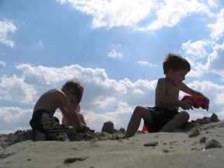 Twin Boys Playing in the Sand on the Beach